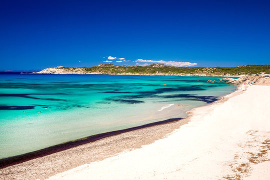 Spiaggia di Rena Maiori beach with azure clear water and mountains, Rena Majore,Sardinia, Italy.