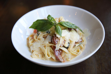 Chorizo sausage spaghetti fettuccine on wood background