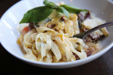 Chorizo sausage spaghetti fettuccine on wood background