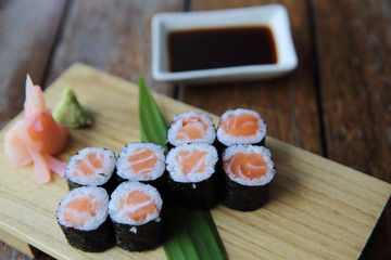 Salmon maki sushi on wood background , Japanese food