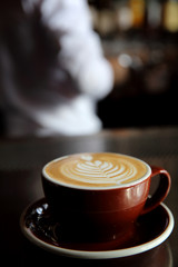 Cappuccino coffee on coffee bar in dark tone