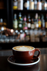 Cappuccino coffee on coffee bar in dark tone