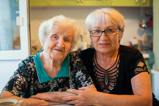 An Elderly Woman With Her Adult Daughter.