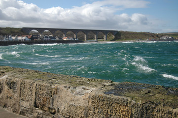 Cullen viaduct viewed from the harbour over a turquoise sea