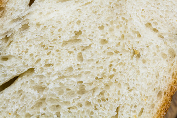 Still life composition with wooden kitchen cutting board and bread on dark background