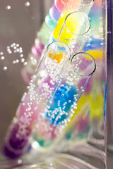 Abstract composition with underwater tubes with colorful jelly balls inside and bubbles
