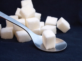 spoon and white sugar cubes