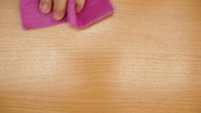 Male hand cleaning table with rag at home kitchen, view from above. People, housework and housekeeping concept. 4K ProRes HQ codec