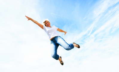 Fototapeta na wymiar Woman In Her 50s Jumping High