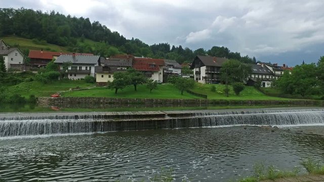 4K. Skofja Loka - one of the oldest cities in Slovenia, located on the rivers. Panoramic view with flowing water and mountains.