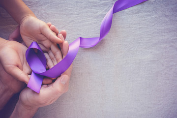 Hands holding Purple ribbons, world cancer day background, Alzheimer disease, Pancreatic cancer,...