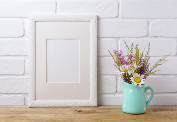 White frame mockup with chamomile and purple field flowers in mint  pitcher