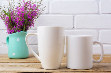 Two white coffee and cappuccino mug mockup with maroon purple flowers in mint pitcher