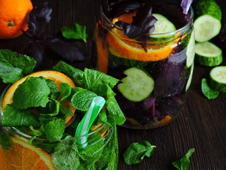 Fresh detox drink with cucumber and orange. Close up.