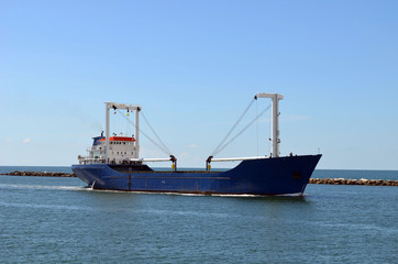 Fototapeta premium Freight ship entering Port of Miami through Government Cut to pick up cargo.
