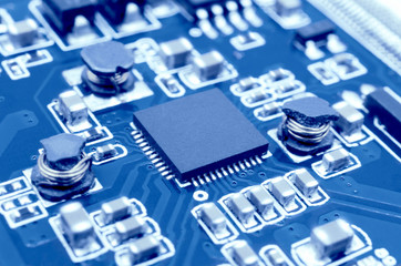 Closeup image of microprocessor on electronic circuit board. Blurred and toned image. Shallow DOF.