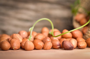 Peanut in burlap bag on old wooden background, close up ,concept of healthy protein power,select focus