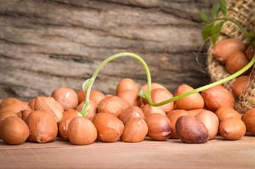 Peanut in burlap bag on old wooden background, close up ,concept of healthy protein power,select focus