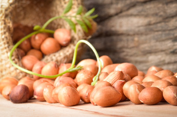 Peanut in burlap bag on old wooden background, close up ,concept of healthy protein power,select focus
