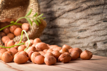 Peanut in burlap bag on old wooden background, close up ,concept of healthy protein power,select focus