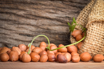 Peanut in burlap bag on old wooden background, close up ,concept of healthy protein power,select focus