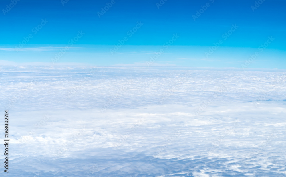 Wall mural blue sky and cloud top view from airplane window,nature background