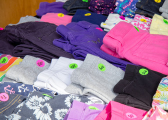 Colorful clothing with price tags at garage sale