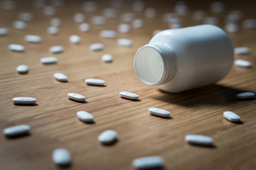 Drug addiction, medical abuse and narcotics hook and dependence concept. Empty tablet bottle...
