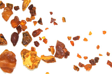 Eight different pieces of amber on a white background.