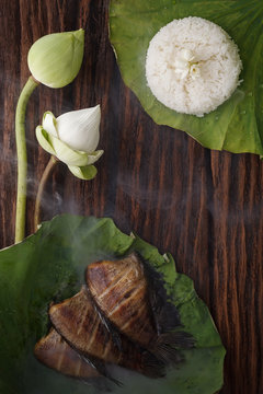 thai food rice and dried salted damsel fish fried with flower lotus jasmine decoration on wooden background