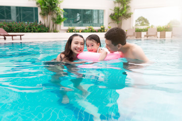 Fototapeta premium Happy family in swimming pool. Summer holidays and vacation concept