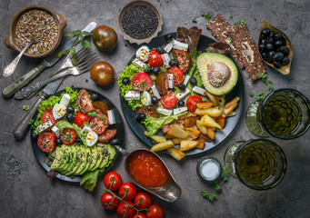 Vegetarian dinner - fried potatoes and fresh vegetable salad