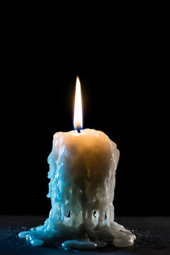 Burning Candle On Grass Plate With Melting Wax Stock Photo, Picture and  Royalty Free Image. Image 23680733.