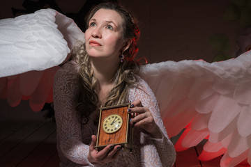 Ugly woman in a white dress with white wings
