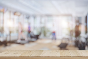 Empty wood table space platform and fitness gym background. Product display montage Concept.