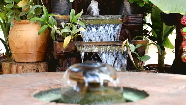 The fountain in the garden. Splashing water from a fountain in the garden.
