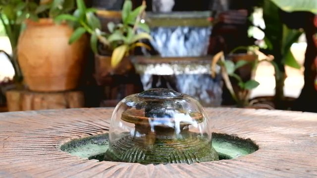 The fountain in the garden. Splashing water from a fountain in the garden.