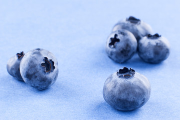 composition of blueberries on a uniform violet background