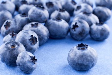 composition of blueberries on a uniform violet background