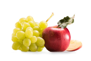 close up view of ripe grapes and apple fruits isolated on white