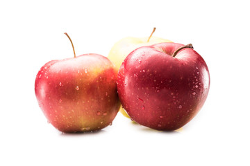 close up view of fresh and ripe apples with water drops isolated on white