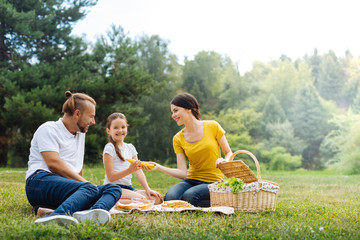 Happy young family having a picnic in the park