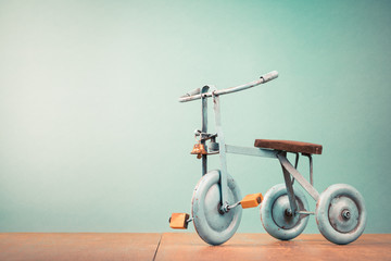 Old retro toy bicycle with three wheels. Vintage instagram style filtered photo