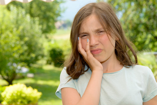 Young cute child girl have a toothache