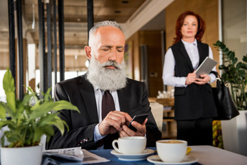 businessman using smartphone in restaurant