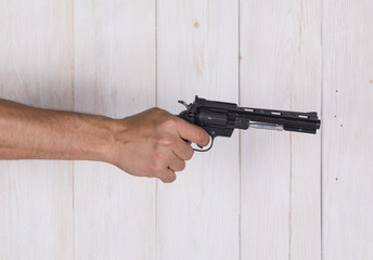 Hand with a black gun