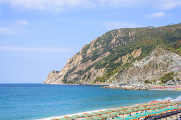 Fototapeta na wymiar Beautiful daylight view to blue sea and green mountains. Monterosso al Mare, Italy. Cinque Terre
