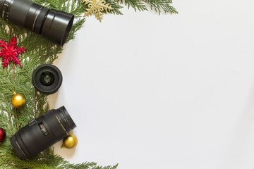 Lenses for reflex camera and Christmas decorations on a white  background