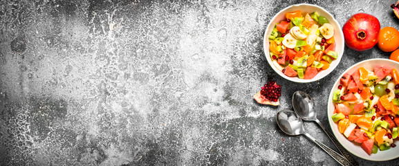 Tropical food . Fresh salad of fruits.