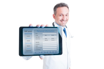 Handsome medic holding modern tablet in hands